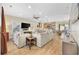 Open concept living space featuring hardwood floors, plush sofas, and a breakfast bar at 132 Garden City Retreat Dr., Murrells Inlet, SC 29576