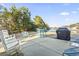 Backyard featuring a lovely pond view, outdoor seating, and a grill, perfect for relaxation and outdoor enjoyment at 1412 Rainsbrook Ct., Conway, SC 29526