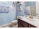 Charming bathroom featuring blue walls, decorative shelves, and modern fixtures at 1412 Rainsbrook Ct., Conway, SC 29526