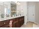 Bathroom with double vanity, dark wood cabinets, white countertops, and modern fixtures at 1412 Rainsbrook Ct., Conway, SC 29526