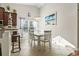 Bright dining room with white table set and modern light fixture under vaulted ceiling. Beach themed decor at 1412 Rainsbrook Ct., Conway, SC 29526