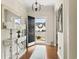 Bright entryway featuring hardwood floors, elegant chandelier, and a view of the front yard through the open door at 1412 Rainsbrook Ct., Conway, SC 29526