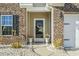 Close-up of a front entrance with brick facade, decorative plants, and an inviting door at 1412 Rainsbrook Ct., Conway, SC 29526