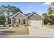Charming brick home with a well-manicured lawn, two-car garage, and a welcoming front porch at 1412 Rainsbrook Ct., Conway, SC 29526