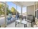 Inviting screened-in patio with lake views, seating, and outdoor grill for entertaining at 1412 Rainsbrook Ct., Conway, SC 29526