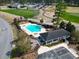 Aerial view of community pool, sun deck, clubhouse, putting green, and golf course at 1412 Rainsbrook Ct., Conway, SC 29526