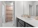 Elegant bathroom with sleek vanity, white countertop, and modern fixtures, complemented by a stylish shower curtain in the background at 1414 Villena Dr., Myrtle Beach, SC 29579