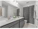 Stylish bathroom featuring double sinks, gray cabinets, and a coordinated shower curtain for a cohesive design at 1414 Villena Dr., Myrtle Beach, SC 29579