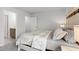 Serene bedroom with floral bedding, soft lighting, and a glimpse into the en-suite bathroom for added convenience at 1414 Villena Dr., Myrtle Beach, SC 29579