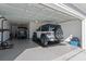 Well-lit garage features epoxy floors, with a white jeep rubicon and golf cart parked inside at 1414 Villena Dr., Myrtle Beach, SC 29579