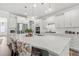 Bright, open kitchen with white cabinetry, a large island, pendant lighting, and stainless steel appliances at 1414 Villena Dr., Myrtle Beach, SC 29579