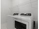 Bright laundry room featuring modern washer and dryer and convenient overhead shelving at 1414 Villena Dr., Myrtle Beach, SC 29579