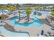 Aerial view of the community's beautiful lazy river with palm trees and lounge chairs at 1414 Villena Dr., Myrtle Beach, SC 29579