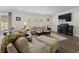 Bright living room featuring a fireplace, TV, comfortable seating, and plenty of natural light at 1414 Villena Dr., Myrtle Beach, SC 29579