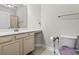 Accessible bathroom featuring a vanity, sink, toilet with supportive arms, and neutral tones at 181 Ella Kinley Circle # 305, Myrtle Beach, NY 29588