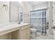 Bathroom featuring a vanity with sink, toilet, and tub with blue seashell shower curtain at 181 Ella Kinley Circle # 305, Myrtle Beach, NY 29588