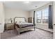 Bright bedroom showcasing a queen bed, dresser, and large window providing ample natural light at 181 Ella Kinley Circle # 305, Myrtle Beach, NY 29588