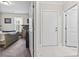 Hallway leading into a bedroom with neutral paint, white trim, doors, and carpet at 181 Ella Kinley Circle # 305, Myrtle Beach, NY 29588
