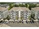 Exterior shot of a multi-story condo building with parking, stairs, and manicured landscaping at 181 Ella Kinley Circle # 305, Myrtle Beach, NY 29588