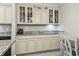 Elegant kitchen with glass-front cabinets, granite countertops, and modern appliances at 181 Ella Kinley Circle # 305, Myrtle Beach, NY 29588
