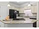 Well-equipped kitchen featuring granite countertops, stainless steel appliances, and modern island at 181 Ella Kinley Circle # 305, Myrtle Beach, NY 29588