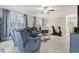 Bright living room featuring a comfortable blue sofa set, neutral walls, and multiple windows for natural light at 181 Ella Kinley Circle # 305, Myrtle Beach, NY 29588