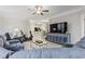 Open concept living room showcasing a media cabinet, exercise bike, and flow into the dining and kitchen area at 181 Ella Kinley Circle # 305, Myrtle Beach, NY 29588