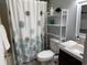 Bathroom with a patterned shower curtain, shelves, and a sink at 1890 Colony Dr. # 17T, Surfside Beach, SC 29575