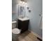 Well-lit bathroom with a modern vanity, decorative mirror, and a toilet at 1890 Colony Dr. # 17T, Surfside Beach, SC 29575