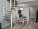 Dining space adjacent to a spiral staircase, with a round table, seating four, beneath modern light fixture at 1890 Colony Dr. # 17T, Surfside Beach, SC 29575