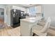 Modern kitchen with updated appliances, white cabinets, and a breakfast bar with stools at 1890 Colony Dr. # 17T, Surfside Beach, SC 29575