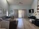 Cozy living room featuring a large sofa, spiral staircase, and access to the balcony at 1890 Colony Dr. # 17T, Surfside Beach, SC 29575