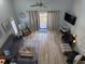 Open-concept living room with a comfortable sofa, stylish decor, and access to a balcony at 1890 Colony Dr. # 17T, Surfside Beach, SC 29575