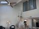 Sun-filled living room with a spiral staircase, ceiling fan and an adjacent dining area at 1890 Colony Dr. # 17T, Surfside Beach, SC 29575