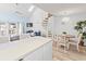 Open-concept living area with dining space, spiral staircase, and bright natural lighting at 1890 Colony Dr. # 17T, Surfside Beach, SC 29575