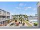 Balcony view of the surrounding community pool and lush landscaping at 1890 Colony Dr. # 17T, Surfside Beach, SC 29575