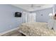 Bedroom includes a TV, ceiling fan and a view to the ensuite bathroom at 2007 S Ocean Blvd. # 2006, Myrtle Beach, SC 29577