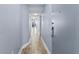 Neutral-toned hallway showcases wood-look flooring and access to the rooms in the condo at 2007 S Ocean Blvd. # 2006, Myrtle Beach, SC 29577