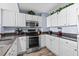 This corner of the kitchen features granite countertops and stainless appliances at 2007 S Ocean Blvd. # 2006, Myrtle Beach, SC 29577