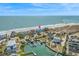 An aerial view of the community, showcasing the canals, homes, beach, and ocean at 2201 S Waccamaw Dr., Murrells Inlet, SC 29576
