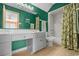 Bathroom featuring bright green walls, a full shower and tub, and a vanity with ample storage space at 2201 S Waccamaw Dr., Murrells Inlet, SC 29576