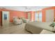 Comfortable bedroom featuring three beds, light wood floors, and a beautiful ocean view from the patio doors at 2201 S Waccamaw Dr., Murrells Inlet, SC 29576