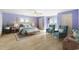 Bright bedroom featuring blue walls, light wood floors, an area rug, and accent chairs at 2201 S Waccamaw Dr., Murrells Inlet, SC 29576