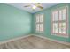 Simple bedroom with wood floors, neutral walls, and two windows with white shutters at 2201 S Waccamaw Dr., Murrells Inlet, SC 29576