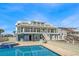 Coastal home exterior featuring a pool and outdoor living spaces at 2201 S Waccamaw Dr., Murrells Inlet, SC 29576