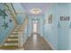 Bright hallway showcasing light wood flooring and an open staircase leading to the upper level at 2201 S Waccamaw Dr., Murrells Inlet, SC 29576