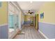 Hallway with hardwood floors, beadboard accents, and outdoor access at 2201 S Waccamaw Dr., Murrells Inlet, SC 29576