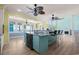A view of the kitchen with a large island, bar seating, range, and view to the outdoors at 2201 S Waccamaw Dr., Murrells Inlet, SC 29576