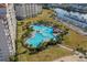 A beautifully landscaped outdoor pool area, complete with mature palm trees, resort amenities, and lush green spaces at 2323 Tidewatch Way, North Myrtle Beach, SC 29582