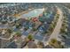 Aerial view of home, community, and pond in a neighborhood with manicured lawns at 2323 Tidewatch Way, North Myrtle Beach, SC 29582